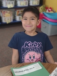 Kindergartener sitting at table